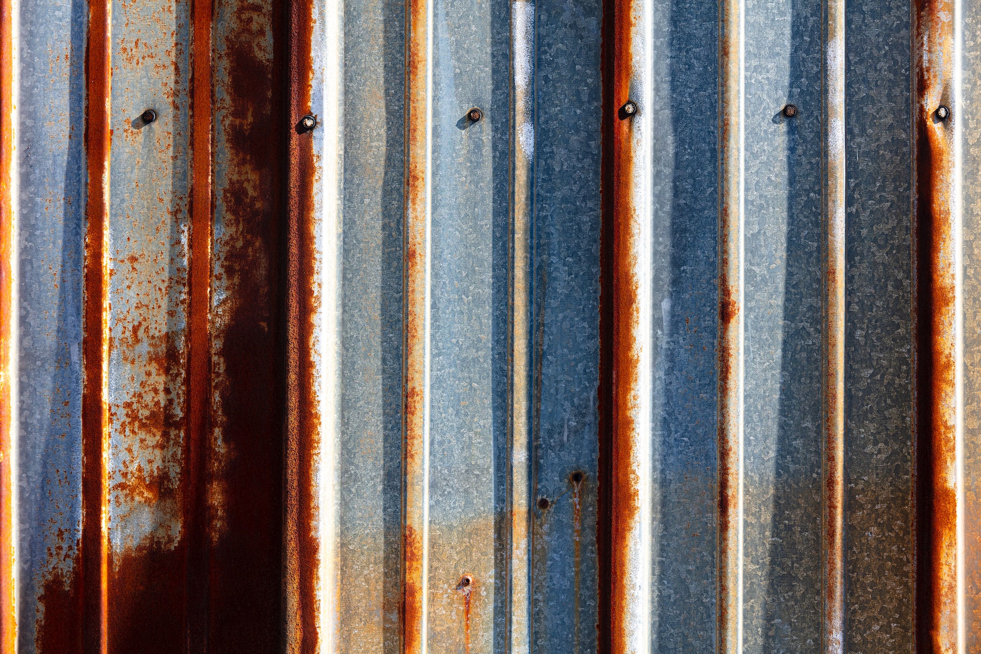 corrugated metal with rust and white spots