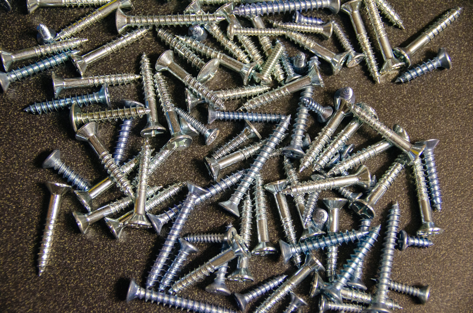 pile of silver screws on table