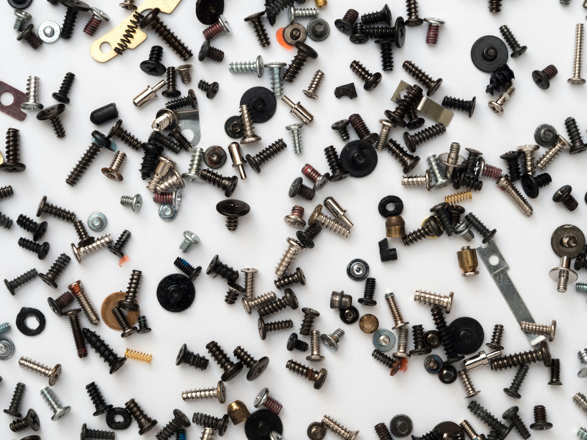 many multicolored fasteners laid out on a white background