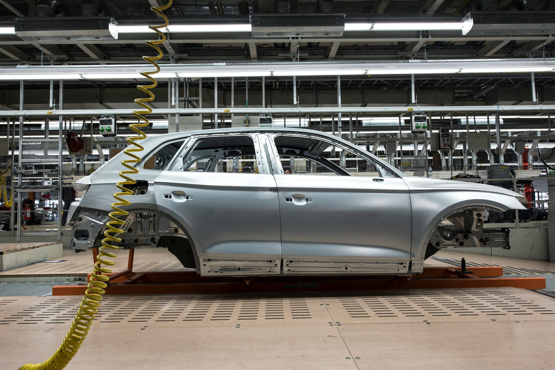 silver car on assembly line